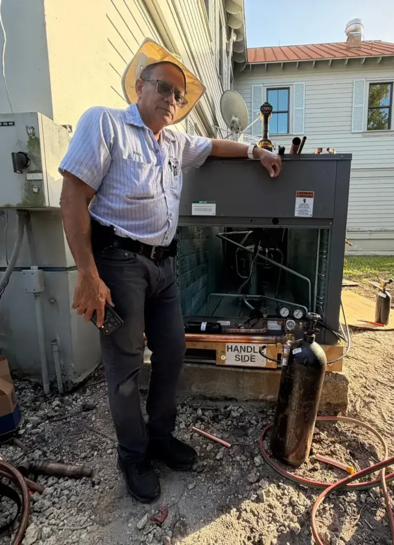 Divino Air owner next to an AC unit he serviced